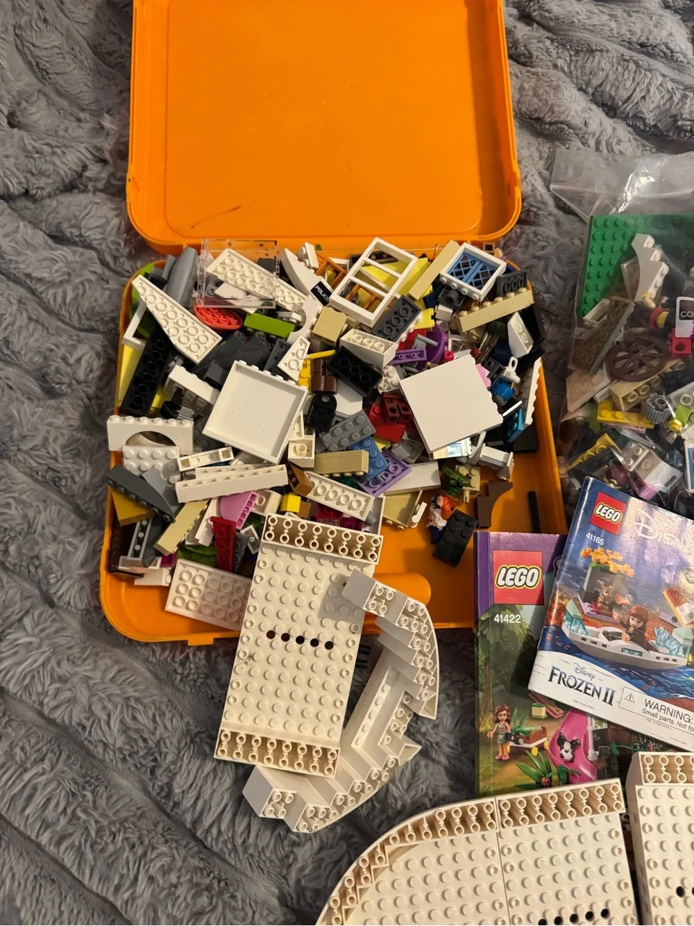 Lego Yellow and Orange Carry Cases filled with Lego bricks and a bag of boards